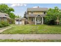 Traditional two-story home with a quaint front yard and a detached garage, showcasing classic curb appeal at 1551 S University Blvd, Denver, CO 80210