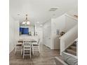 Bright and airy dining room featuring a modern table, open layout, and hardwood floors at 643 S Norfolk Way, Aurora, CO 80017