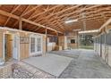 Spacious barn interior featuring wood construction, ample lighting, and stall areas for horses or livestock at 36700 Mossberg Ct, Elizabeth, CO 80107