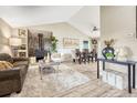Inviting living room with wood-burning stove, vaulted ceilings, and an open floor plan that seamlessly connects to the dining area at 36700 Mossberg Ct, Elizabeth, CO 80107
