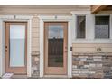 Close-up of the front door and entrance with stone accent and painted trim detail at 11250 Florence St # 29D, Commerce City, CO 80640