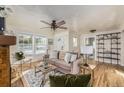 Spacious living room with hardwood floors and a view into the kitchen at 7121 W 52Nd Ave, Arvada, CO 80002