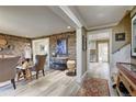 Bright and airy entryway with stone wall and view into the kitchen at 1641 Castlewood Dr, Franktown, CO 80116