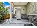 Close up of front porch and front door with stone accents and manicured landscaping at 18372 E 100Th Pl, Commerce City, CO 80022