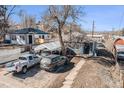 Blue single story home with a large tree in the front yard and multiple parked cars at 47 Osceola St, Denver, CO 80219
