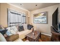 Comfortable living room with a plush sofa, cozy decor, and natural light at 47 Osceola St, Denver, CO 80219