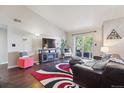 Bright living room with hardwood floors and balcony access at 875 E 78Th Ave # 7, Denver, CO 80229