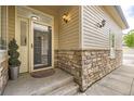 Inviting front entryway with stone accents and stylish outdoor lighting at 4346 S Quail St, Littleton, CO 80127