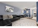 Comfortable living room with modern decor and black leather couch, ideal for relaxation and entertainment at 1310 N Corona St # A, Denver, CO 80218