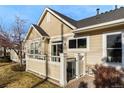 Charming home exterior with a fenced patio, updated paint, and well-kept landscaping at 6606 S Reed Way # B, Littleton, CO 80123