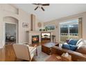Comfortable living room with a fireplace, natural light, and hardwood floors at 6606 S Reed Way # B, Littleton, CO 80123