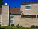 Exterior view of the building showing architectural details and private fenced patio at 7640 S Monaco W Cir, Centennial, CO 80112