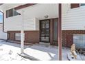 Covered entryway with brick facade and decorative iron door at 995 S Upham St, Lakewood, CO 80226