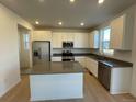 Modern kitchen with island, stainless steel appliances, and light cabinetry at 191 Freemont Ct, Brighton, CO 80601