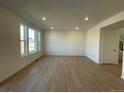 Spacious living room with hardwood floors and large windows at 191 Freemont Ct, Brighton, CO 80601