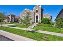 A well-maintained lawn and landscaped walkway lead to the front door of this charming home at 12121 Bryant St, Westminster, CO 80234