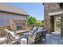 Inviting outdoor patio features a stone fireplace and comfortable seating area at 12121 Bryant St, Westminster, CO 80234