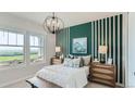 Bedroom with green and white accent wall, and a view at 10736 Snowdon St, Parker, CO 80134