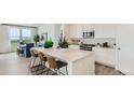 Modern kitchen with white cabinets and a large island at 10736 Snowdon St, Parker, CO 80134