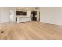 Open floor plan with hardwood floors connecting the living and kitchen areas at 10736 Snowdon St, Parker, CO 80134