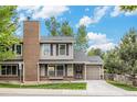 Charming two-story home showcasing a brick chimney, covered entryway, and attached one-car garage at 4116 W 111Th Cir, Westminster, CO 80031