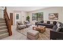 Inviting living room featuring a large window, comfortable seating, and a cozy rug at 4116 W 111Th Cir, Westminster, CO 80031