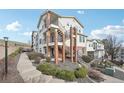Wide angle exterior view of a multi-story building with staircase and balconies, surrounded by lush landscaping at 1629 S Deframe St # A1, Lakewood, CO 80228