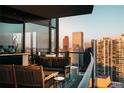 Relax on this expansive outdoor balcony with city views, including sleek furniture and a built-in bar at 1133 14Th St # 3430, Denver, CO 80202