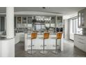 Bright, modern kitchen with marble counters, crystal chandelier, and seating at 1133 14Th St # 3430, Denver, CO 80202