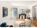 Bright living room featuring hardwood floors, modern furnishings, and a stylish entry door at 2680 S Garfield Cir, Denver, CO 80210
