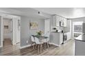 Bright dining area with glass table and four white chairs at 3550 S Harlan # 144, Denver, CO 80235