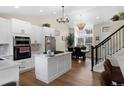 Modern kitchen featuring white cabinetry, stainless steel appliances, island, and an adjacent dining area with plenty of natural light at 613 N Brentwood Ct, Castle Rock, CO 80104