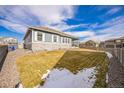 Large backyard with a grassy area and gravel landscaping at 1680 Rivergate Way, Berthoud, CO 80513