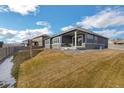 Spacious backyard with a patio and grassy area at 1680 Rivergate Way, Berthoud, CO 80513