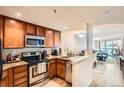 Cozy kitchen features stainless steel appliances and seamless access to the adjacent living space at 100 Park W Ave # 201, Denver, CO 80205