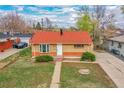 An aerial view shows a well-maintained home with a landscaped front yard and driveway at 6990 Larsh Dr, Denver, CO 80221