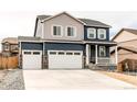 Beautiful two-story home with a three-car garage, stone detailing, and inviting front porch at 13921 Scarlet Sage Ln, Parker, CO 80134