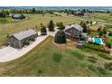 Expansive aerial view showcasing a home with detached garage and well-manicured lawn at 8682 N Sundown Trl, Parker, CO 80134