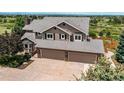 Beautiful home featuring a brick and siding exterior, complemented by a spacious three-car garage at 8682 N Sundown Trl, Parker, CO 80134