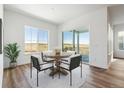 Bright dining area with wood flooring and an outdoor view at 6653 Bridlespur St, Castle Pines, CO 80108