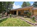 Attractive brick home featuring manicured landscaping and a charming walkway leading to the entrance at 7577 S Pierce Way, Littleton, CO 80128