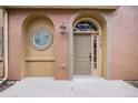 Inviting front entrance with a tan-colored door and arched window at 10127 Bluffmont Ln, Lone Tree, CO 80124