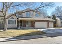 Charming two-story home with a brick facade and a three-car garage at 1642 S Trenton St, Denver, CO 80231