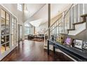 Elegant foyer with hardwood floors and a staircase leading to a spacious living room at 1642 S Trenton St, Denver, CO 80231