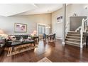 Bright living room featuring hardwood floors, vaulted ceilings, and large windows at 1642 S Trenton St, Denver, CO 80231