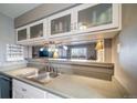 Kitchen features pass-through to living room and ample storage at 7700 W Glasgow Pl # 19C, Littleton, CO 80128