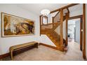 Grand foyer with wood staircase, large artwork, and tiled flooring at 1007 N Ogden St, Denver, CO 80218