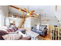 Spacious living room with hardwood floors, high ceilings, ceiling fans, and cozy furnishings at 11348 Ranch Elsie Rd, Golden, CO 80403