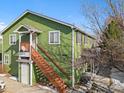 Green duplex building with stairs and surrounding trees at 3226 W Girard Ave # D, Englewood, CO 80110