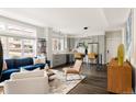 Open-concept living room and kitchen with hardwood floors, blue sofa, and stainless steel appliances at 801 8Th St, Golden, CO 80401
